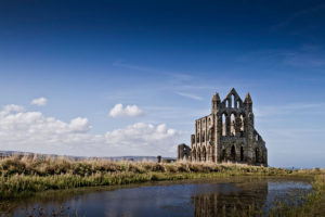 Old church building in disrepair in a grassy field