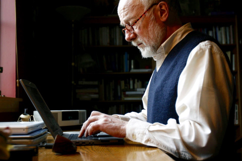 Marcus Borg, progressive Christian author, working at a laptop