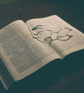 glasses on an open Bible showing Christianity resources